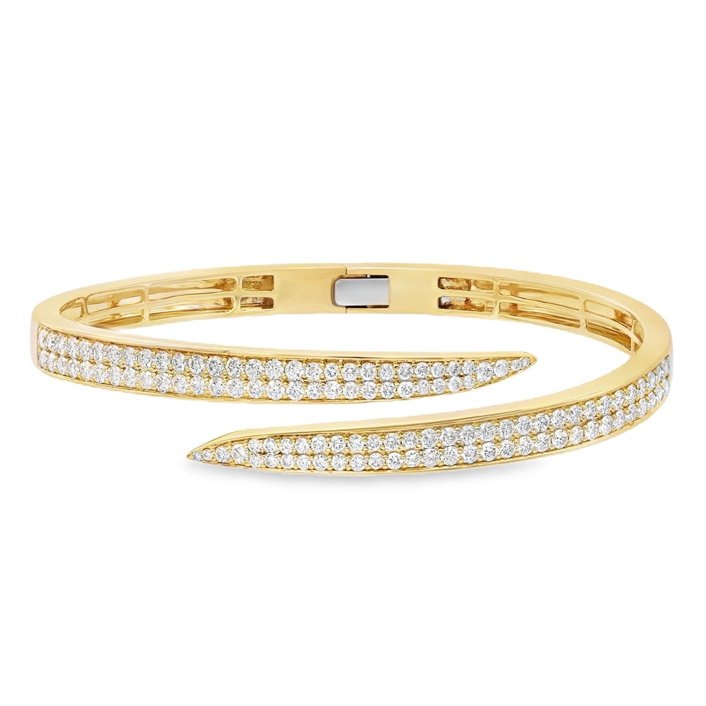 18K yellow gold pavé bypass bangle featuring approximately 3.00 carats of G-H color SI clarity diamonds.