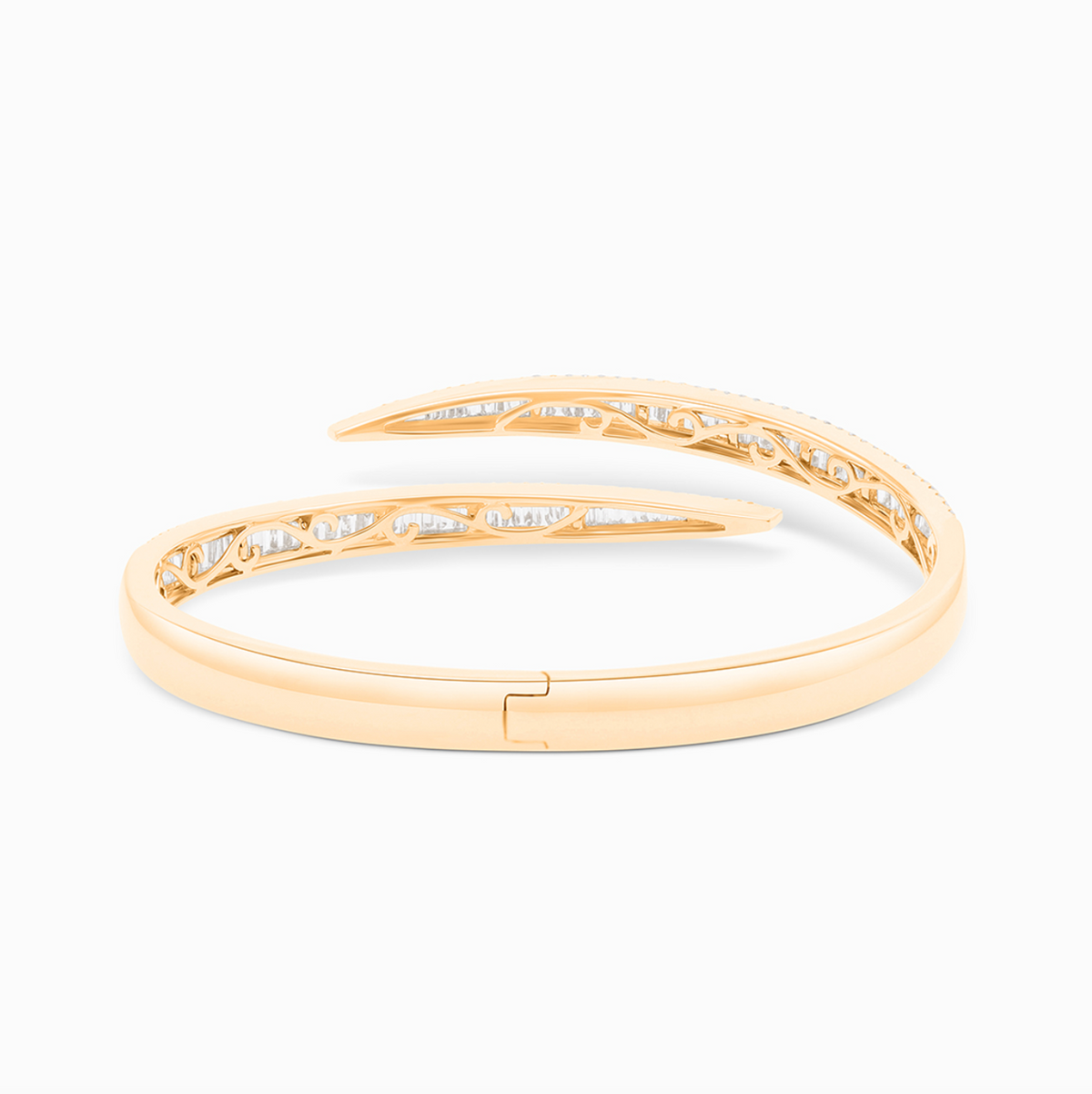 Yellow gold open bangle with round and baguette diamond accents totaling 4.06 carats.