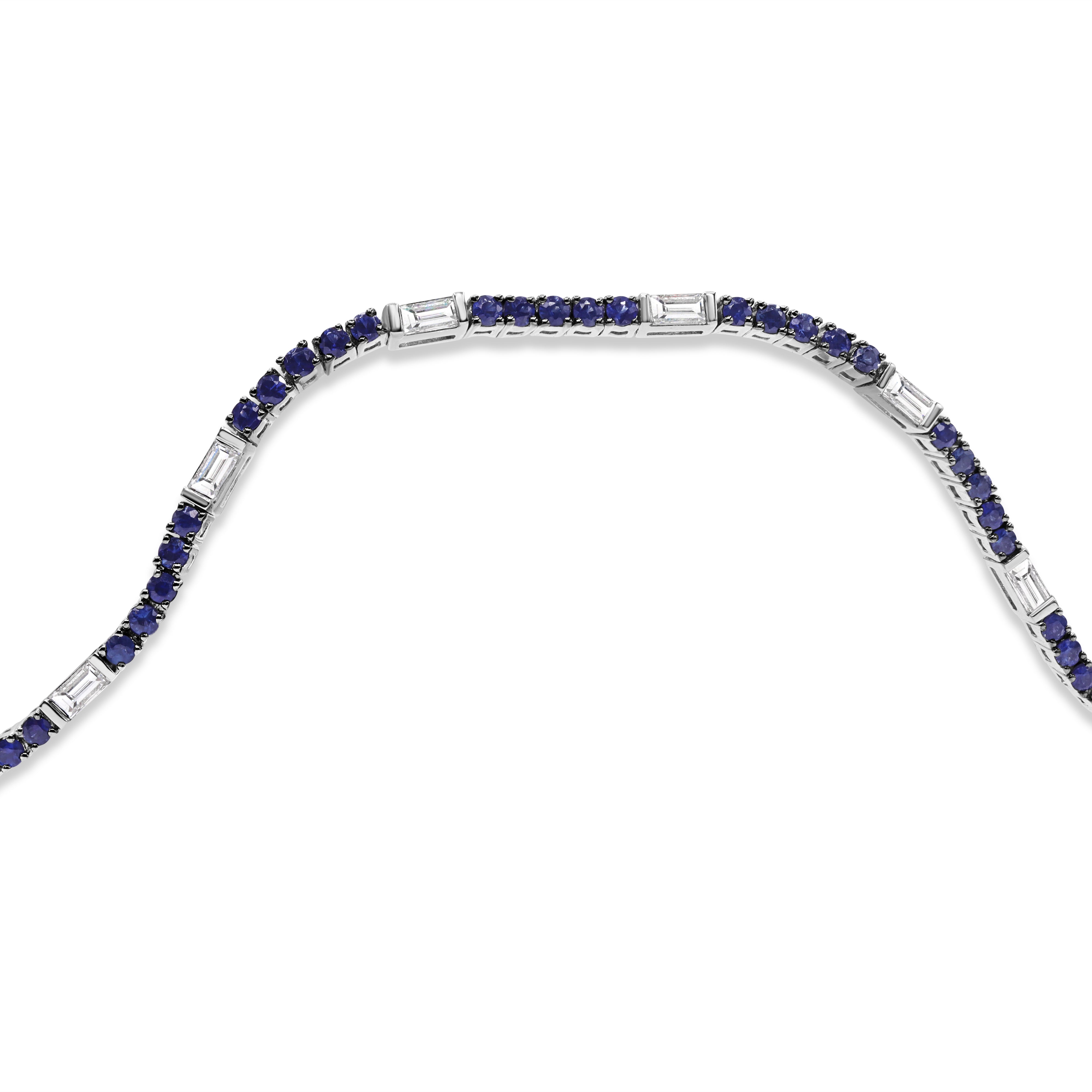 Blue sapphire and baguette diamond tennis bracelet in 14K gold featuring alternating sapphires and baguette diamonds in a modern, elegant design.