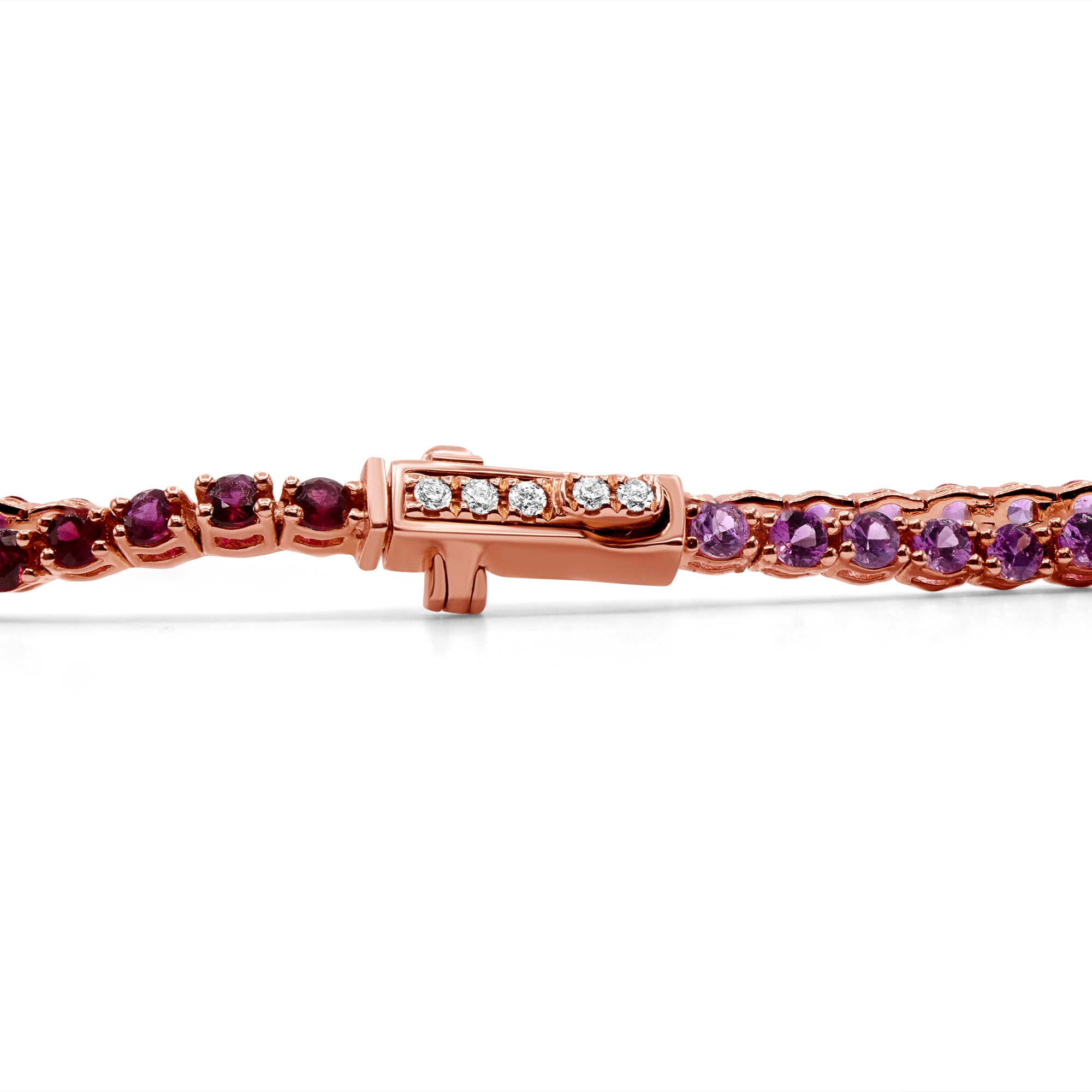 Ruby and pink sapphire bracelet in 14K gold featuring round diamond accents in a colorful, elegant design.