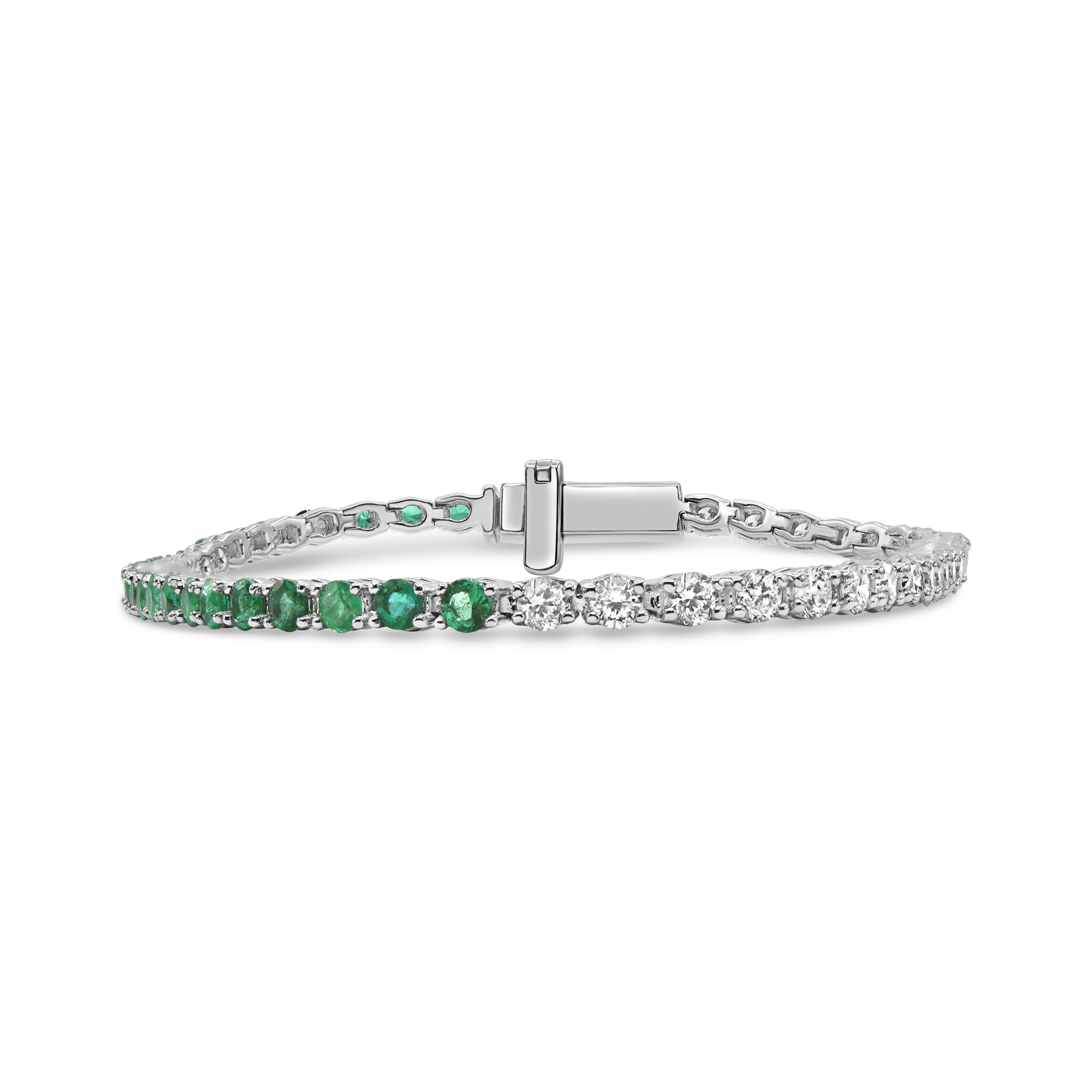 14K gold tennis bracelet featuring alternating green emeralds and round diamonds in an elegant design.