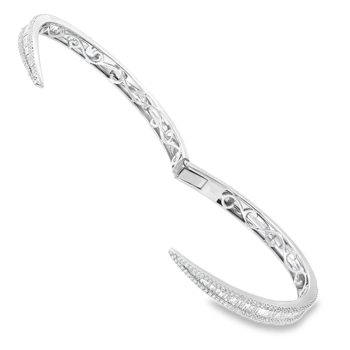Elegant white gold diamond bangle featuring natural round and baguette diamonds in a sleek bypass design.