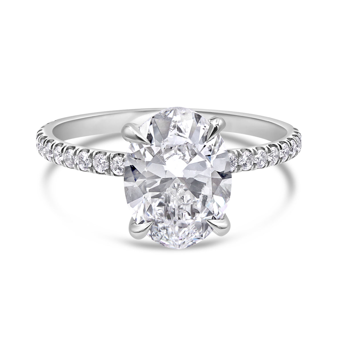 Platinum oval diamond ring featuring a 2.00 carat oval cut center diamond, round diamond accents, and a subtle hidden halo.