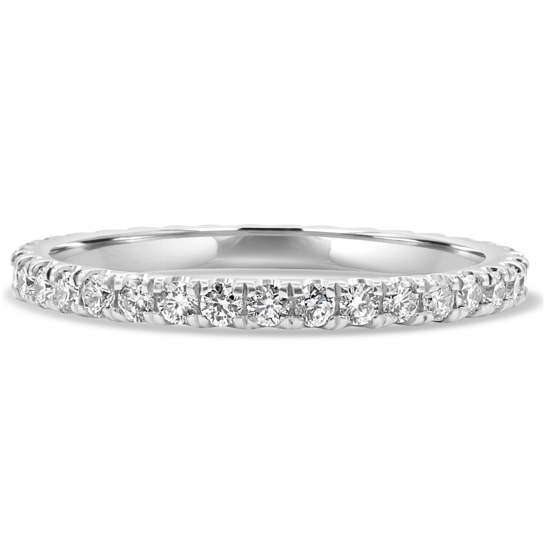 Platinum micro pavé wedding band featuring 36 brilliant round diamonds totaling 0.61 CTW in a handmade low-profile design.