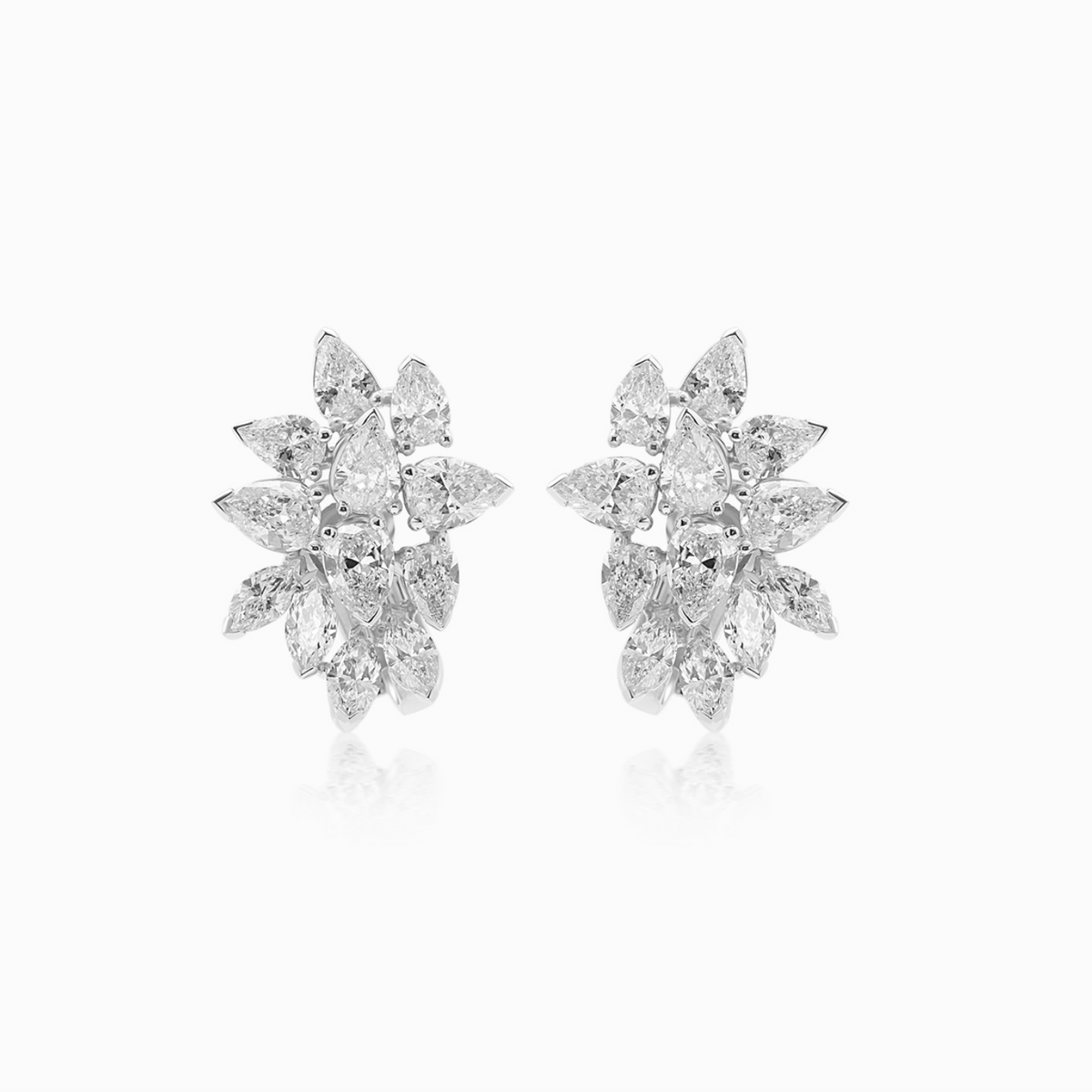 Platinum diamond cluster earrings featuring pear-shaped and marquise diamonds arranged in an elegant floral-inspired design.