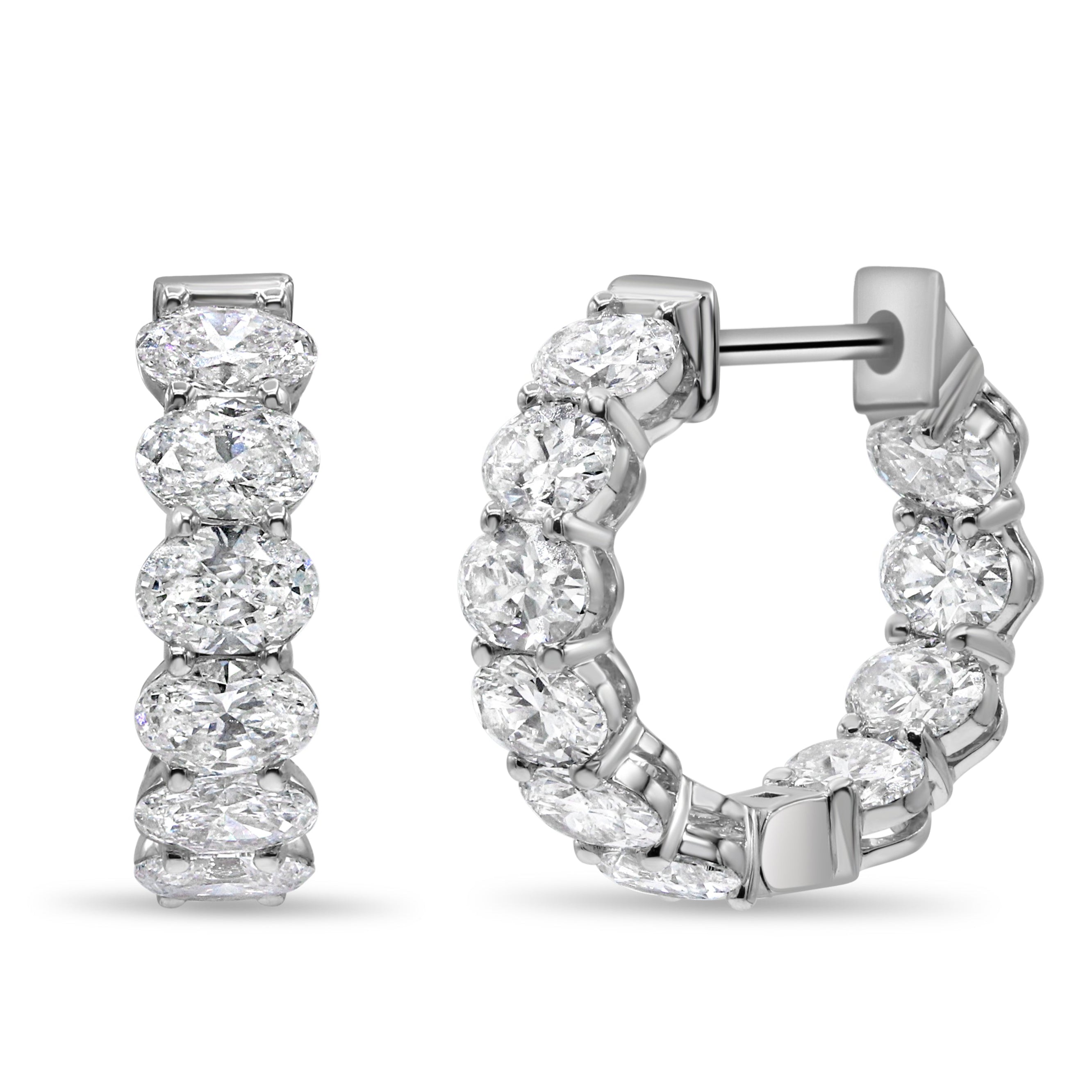 14K white gold mini huggie earrings featuring lab grown oval cut diamonds with E-F color and VS1-VS2 clarity.