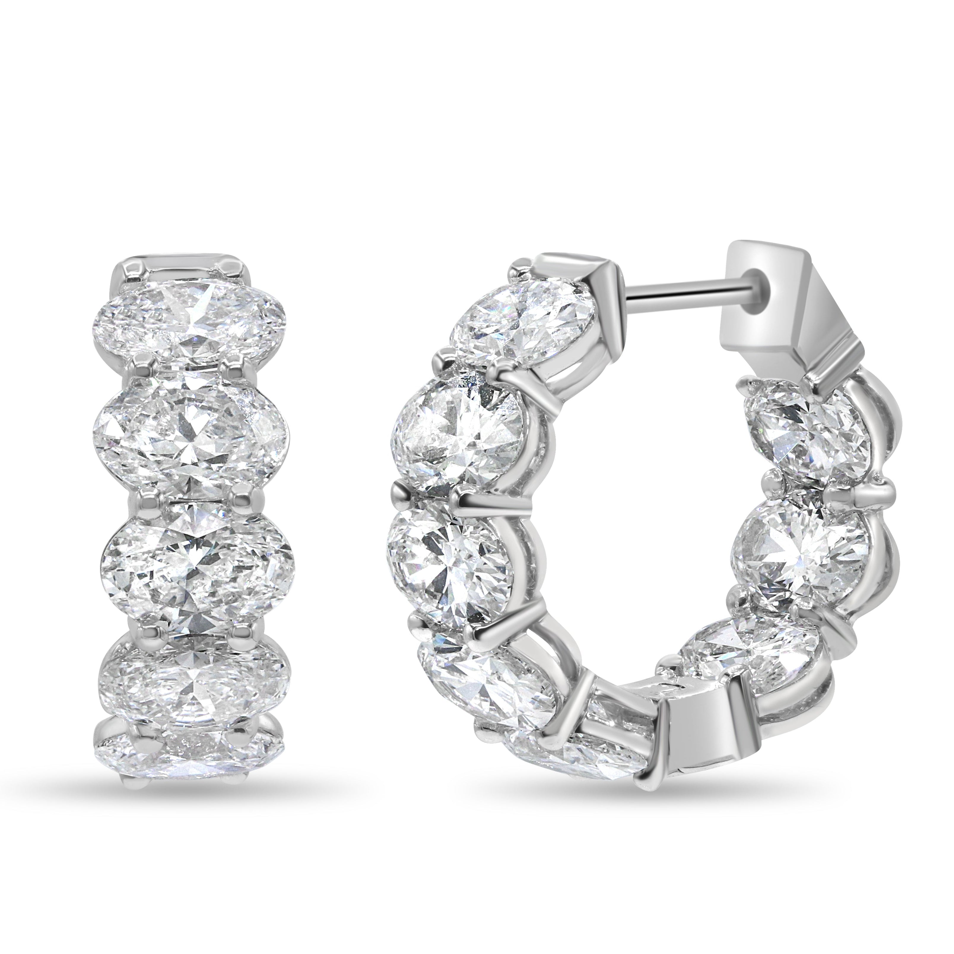 Lab grown oval cut diamond huggie earrings in 14K white gold featuring oval cut diamonds in a modern, elegant design.