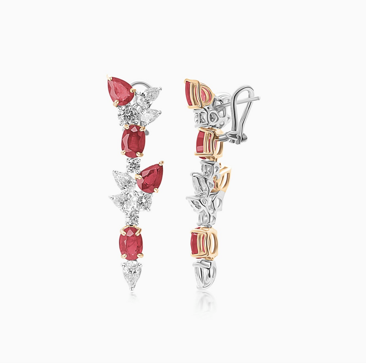 Platinum and 18K yellow gold ruby and diamond drop earrings with a sophisticated fancy design.