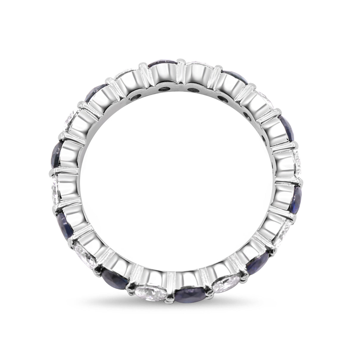 Platinum diamond and blue sapphire eternity band with alternating gemstones.