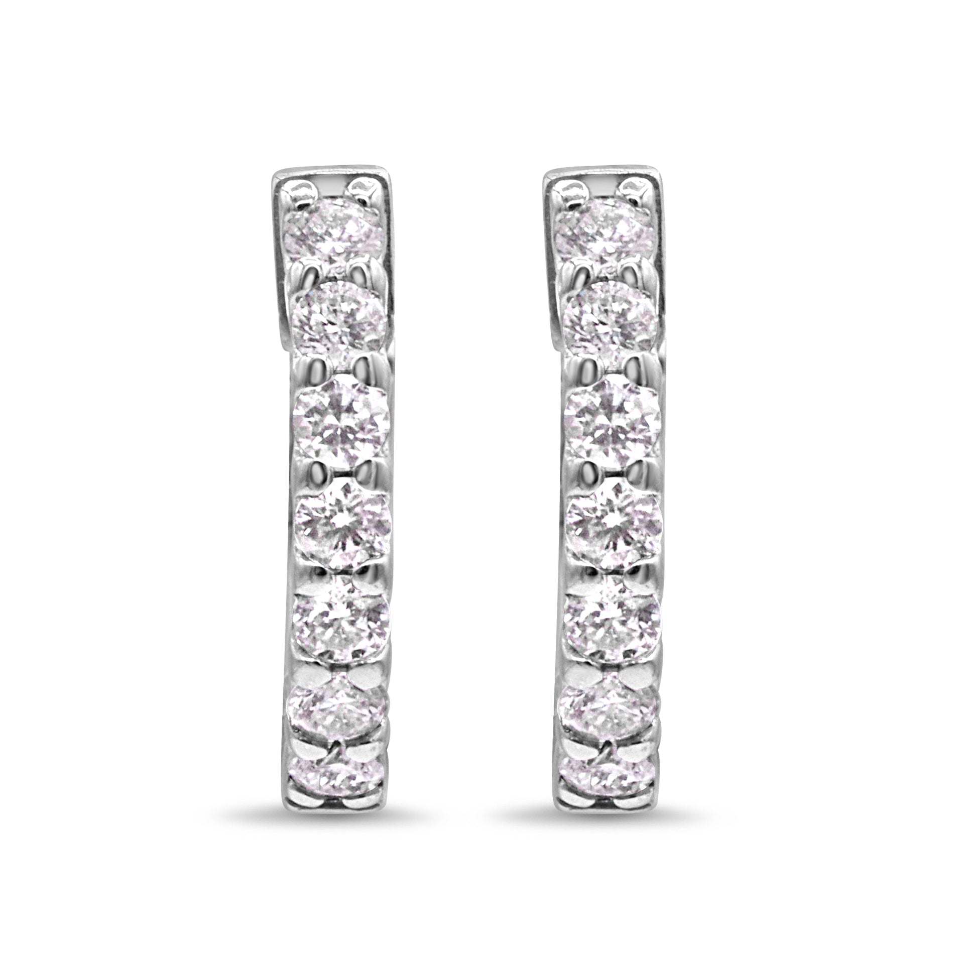 14K white gold huggie earrings featuring 14 round brilliant diamonds in a sleek row setting.
