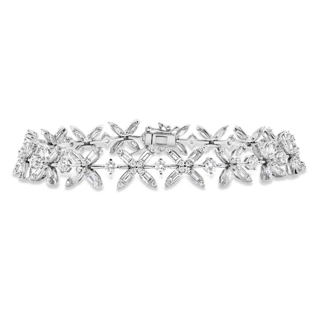 18K gold petite floral bracelet featuring baguette cut diamonds totaling 4.78 CTW with round diamond accents.