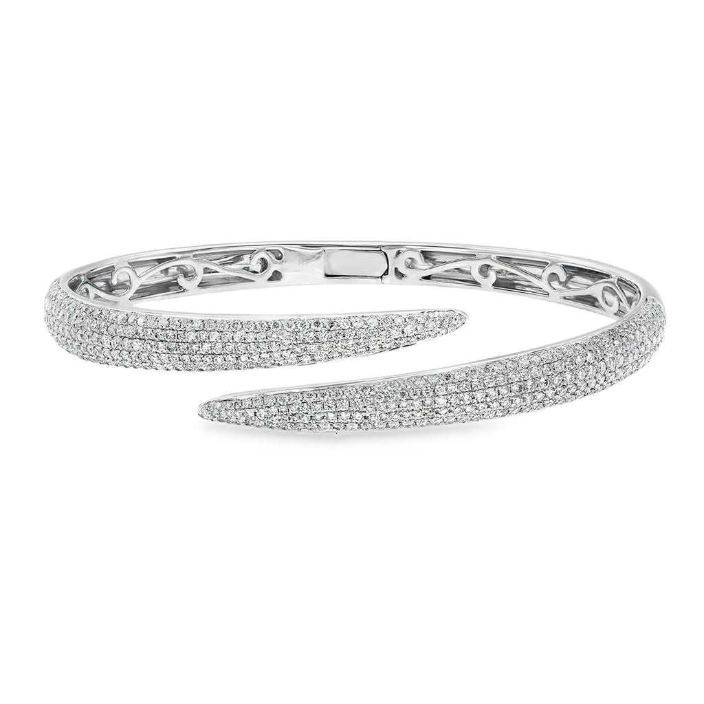 18K white gold pavé bypass bangle featuring approximately 3.00 carats of G-H color SI clarity diamonds wrapping around the bangle.