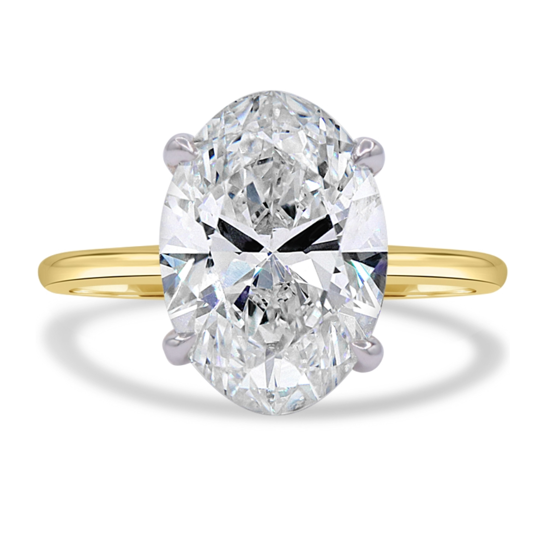 18K yellow gold and platinum ring featuring a 4.01 carat lab-grown oval diamond with H color and VS1 clarity in a classic four-prong basket setting.