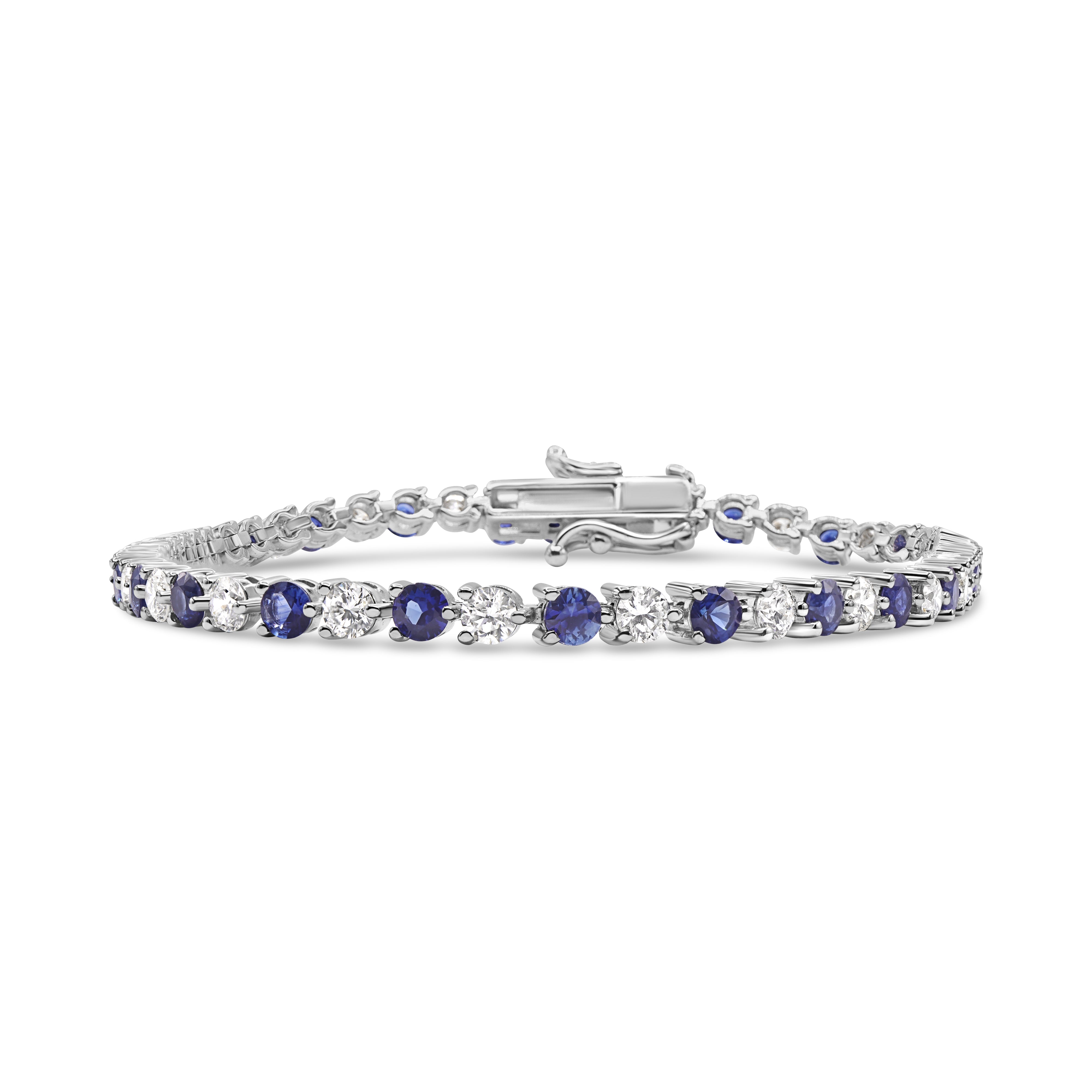 18K gold bracelet featuring alternating round diamonds and blue sapphires in an elegant tennis design.