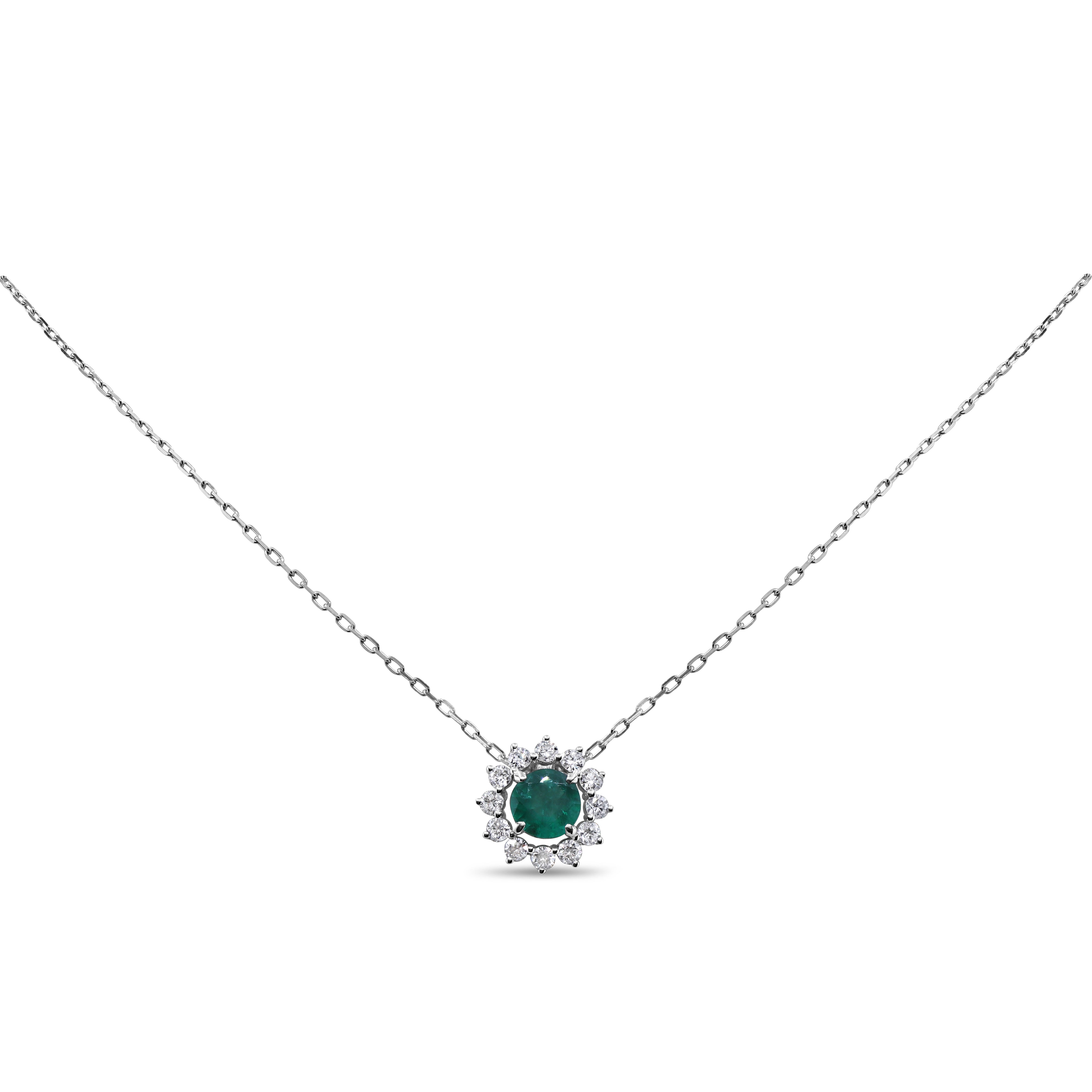 Green emerald and diamond pendant in 14K gold featuring a prong-set emerald with a round diamond halo in a classic, elegant design.