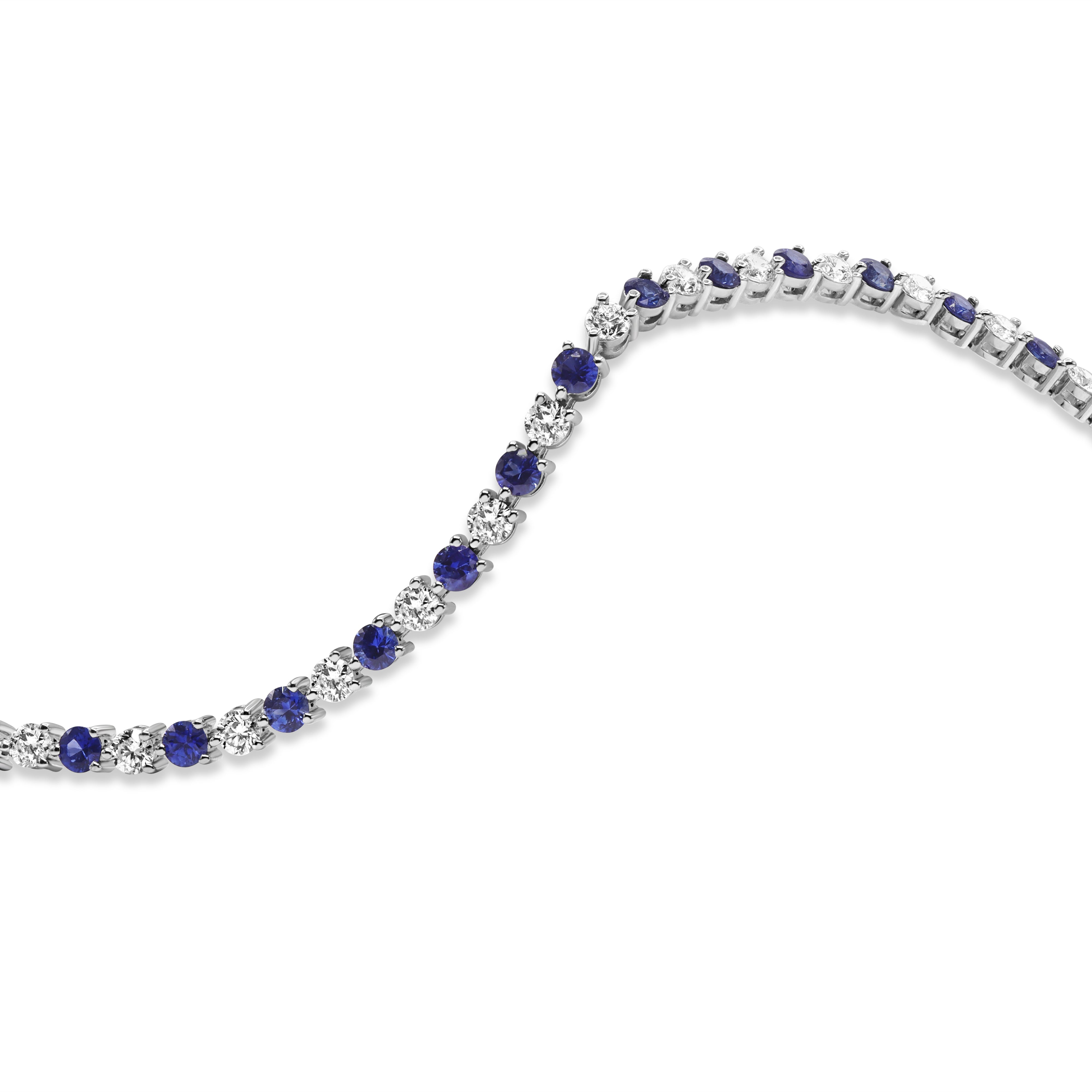 Alternating blue sapphire and diamond bracelet in 18K gold featuring round diamonds and blue sapphires in a classic, refined design.