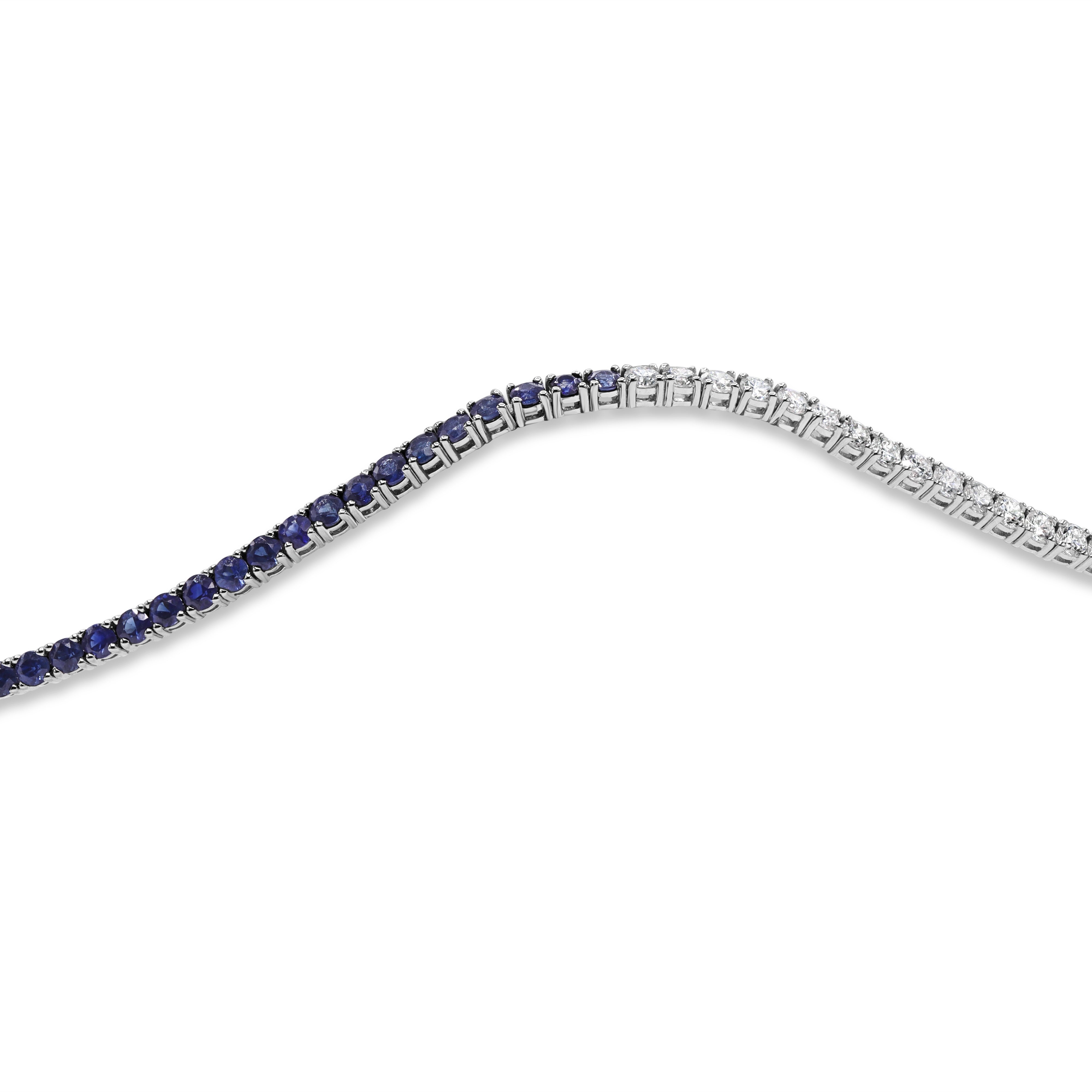 Diamond and blue sapphire tennis bracelet in 14K gold featuring round brilliant diamonds and blue sapphires in a half-and-half design.
