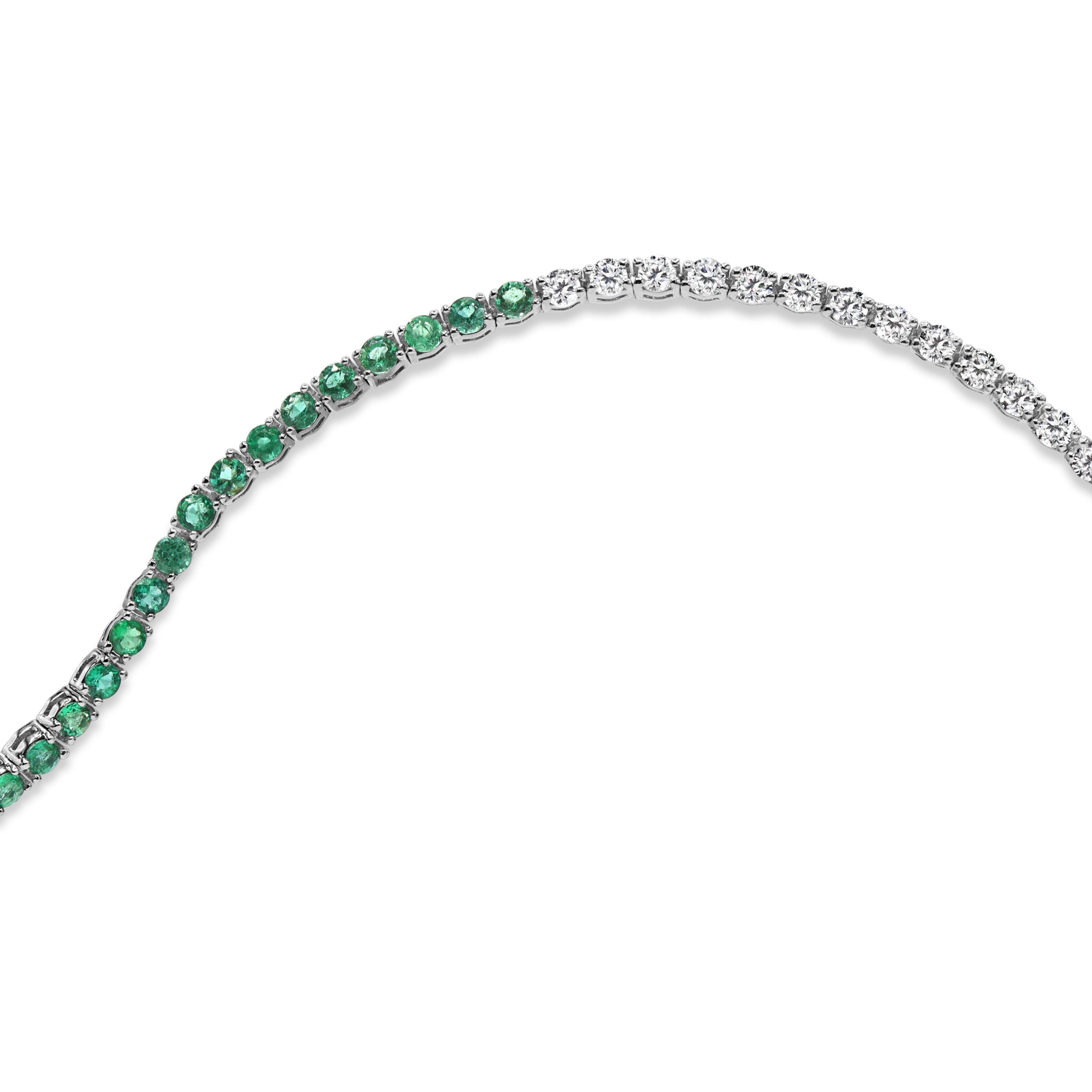 Diamond and green emerald tennis bracelet in 14K gold featuring round diamonds and green emeralds in an alternating design.