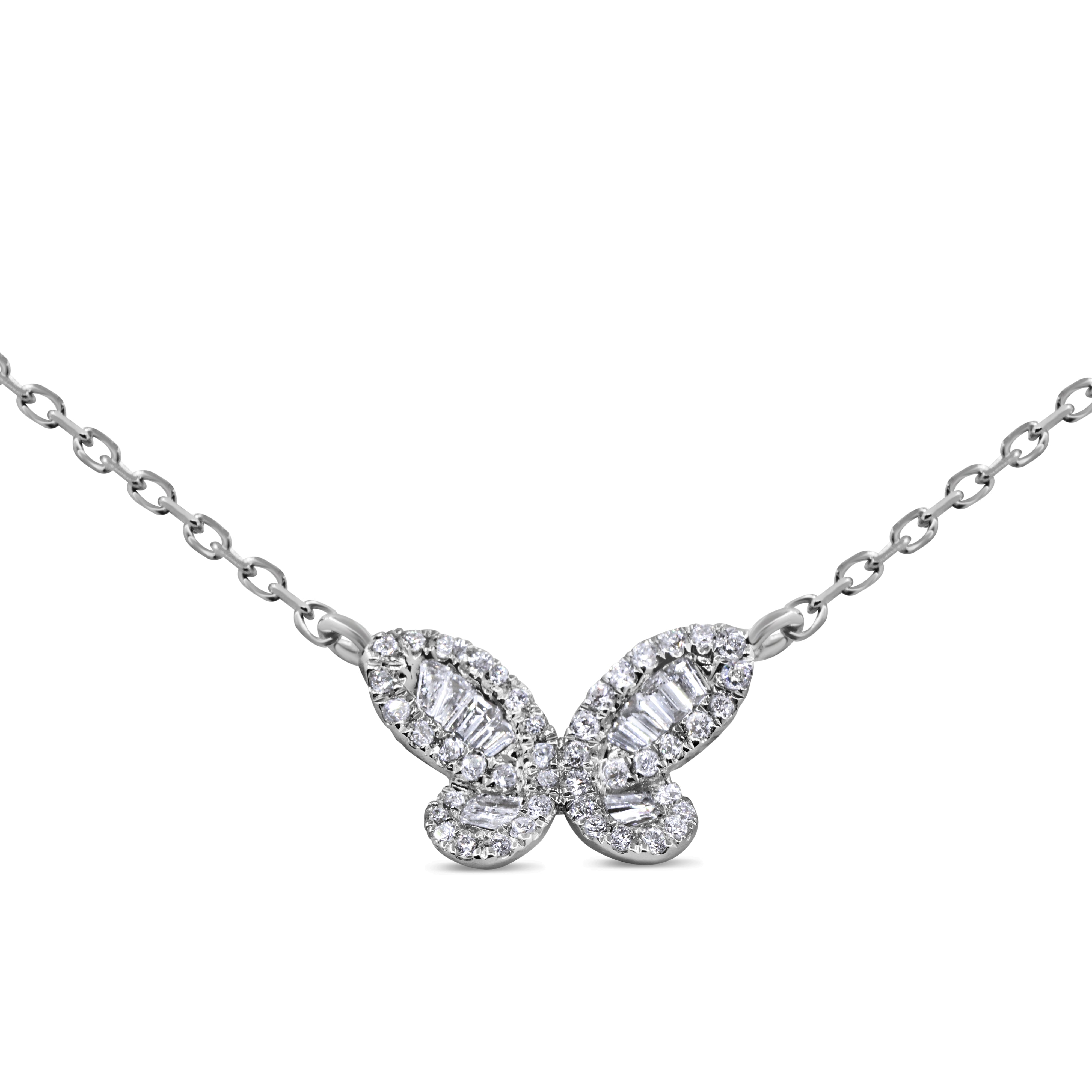 Mini diamond butterfly pendant in 14K white gold featuring baguette and round brilliant diamonds in a delicate, modern design.