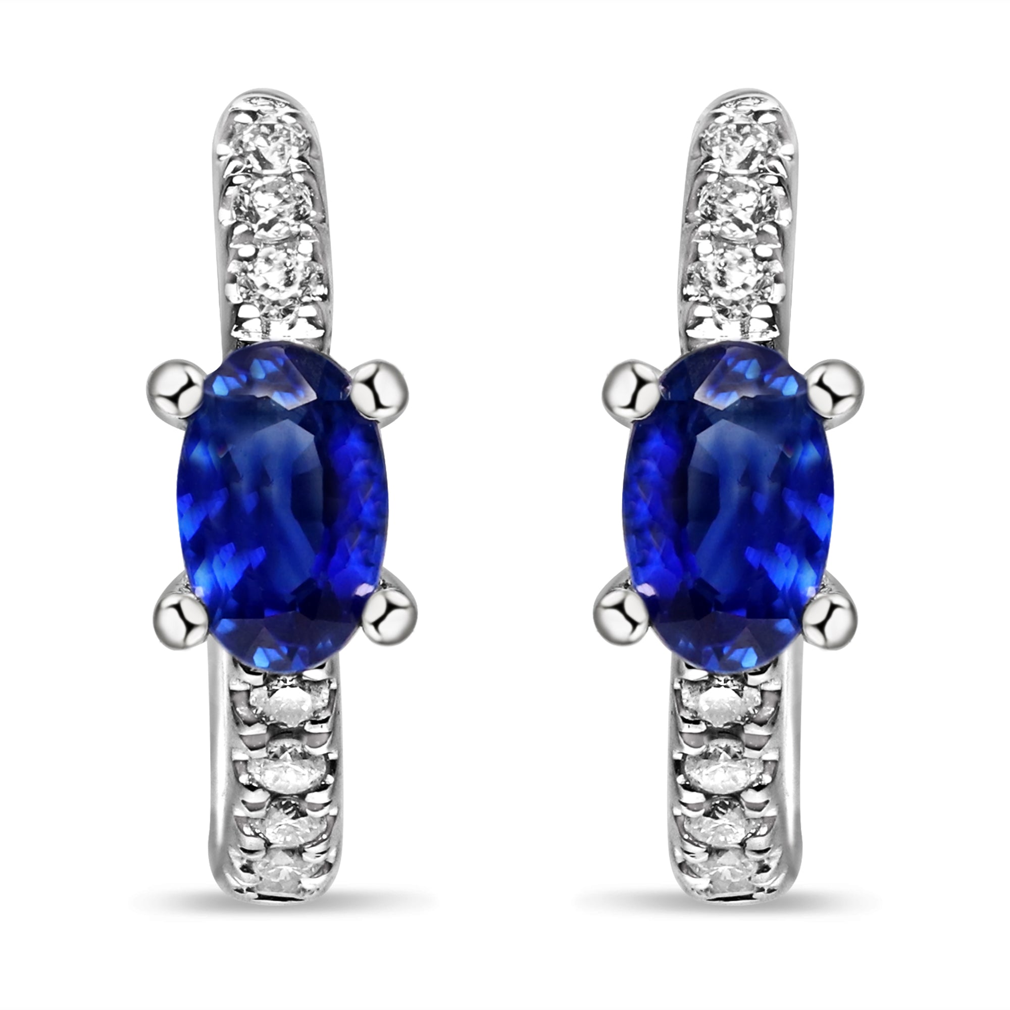 14K white gold huggie earrings featuring blue sapphires and round diamonds in a modern hoop silhouette.