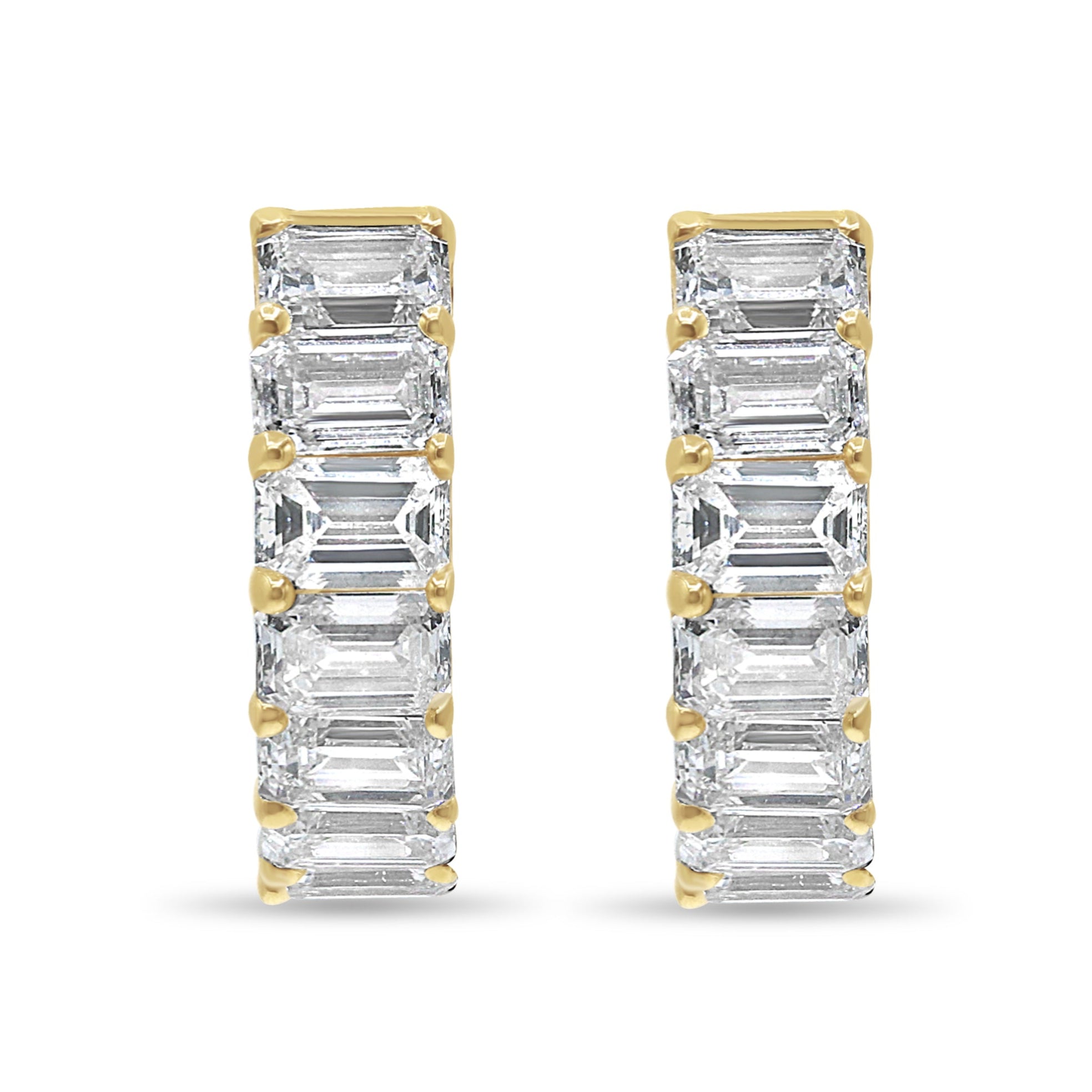 14K yellow gold mini huggie earrings featuring lab grown emerald cut diamonds with E-F color and VS1-VS2 clarity.