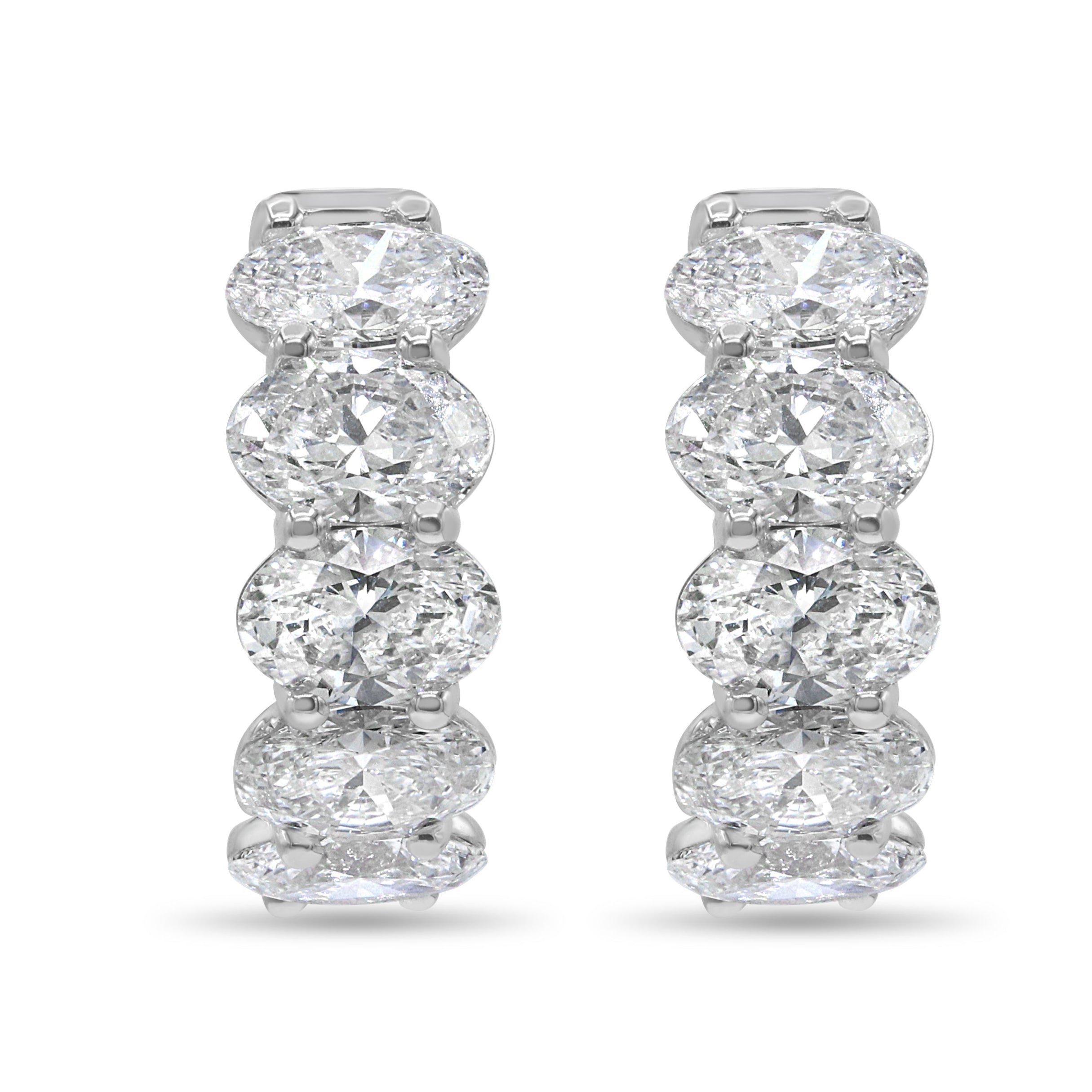 14K white gold huggie earrings featuring lab grown oval cut diamonds with E-F color and VS1-VS2 clarity.