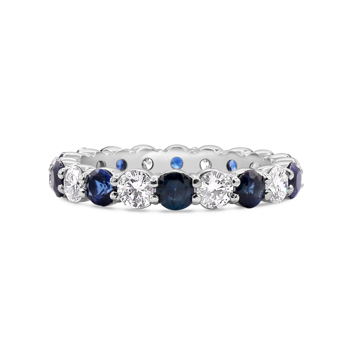 Platinum eternity band featuring 10 round diamonds totaling 1.00 CTW and 10 blue sapphires totaling 1.12 CTW.