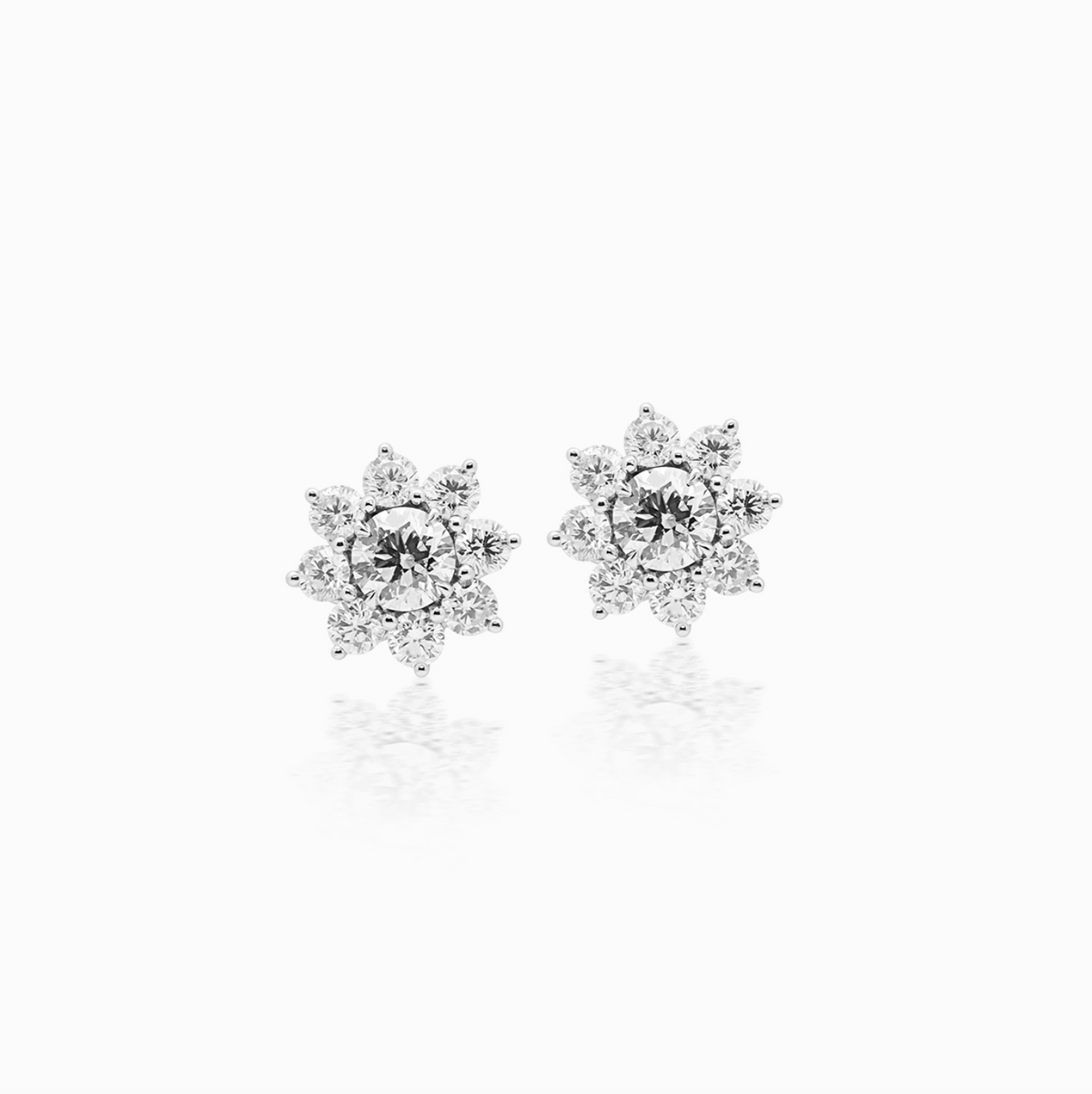 Platinum sun diamond cluster stud earrings featuring diamonds arranged in a radiant sun-inspired design.