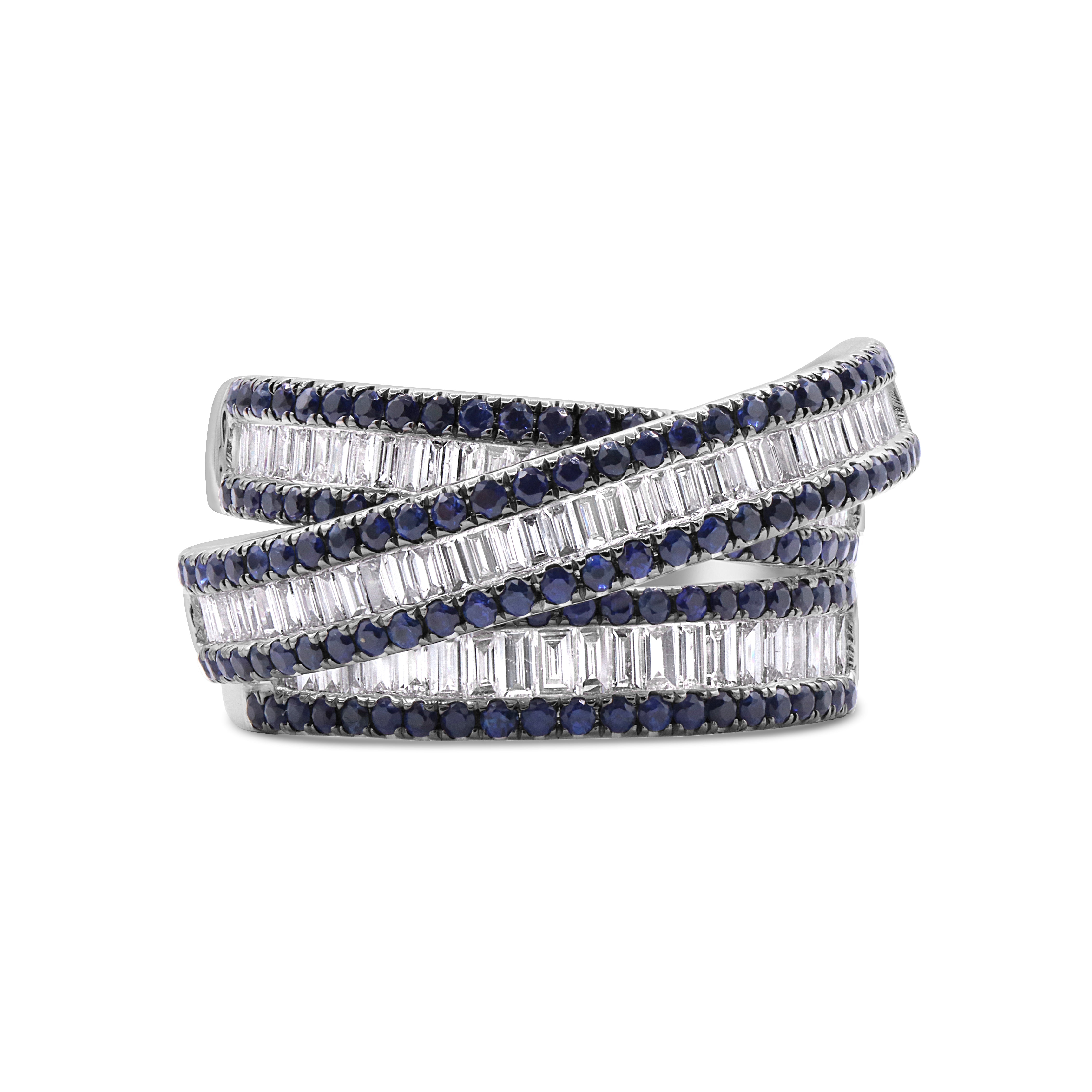 18K white gold criss cross ring featuring 92 baguette diamonds and 145 blue sapphires in a bold, elegant design.