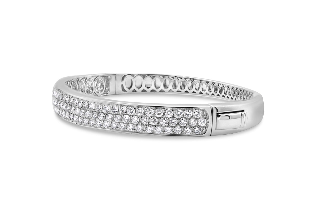 14K white gold multi-row pavé diamond bangle with round brilliant and oval diamond accents.