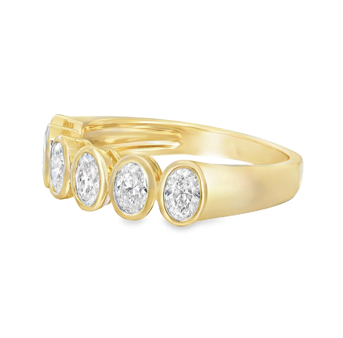 18K yellow gold oval bezel set diamond ring with a sleek modern design.