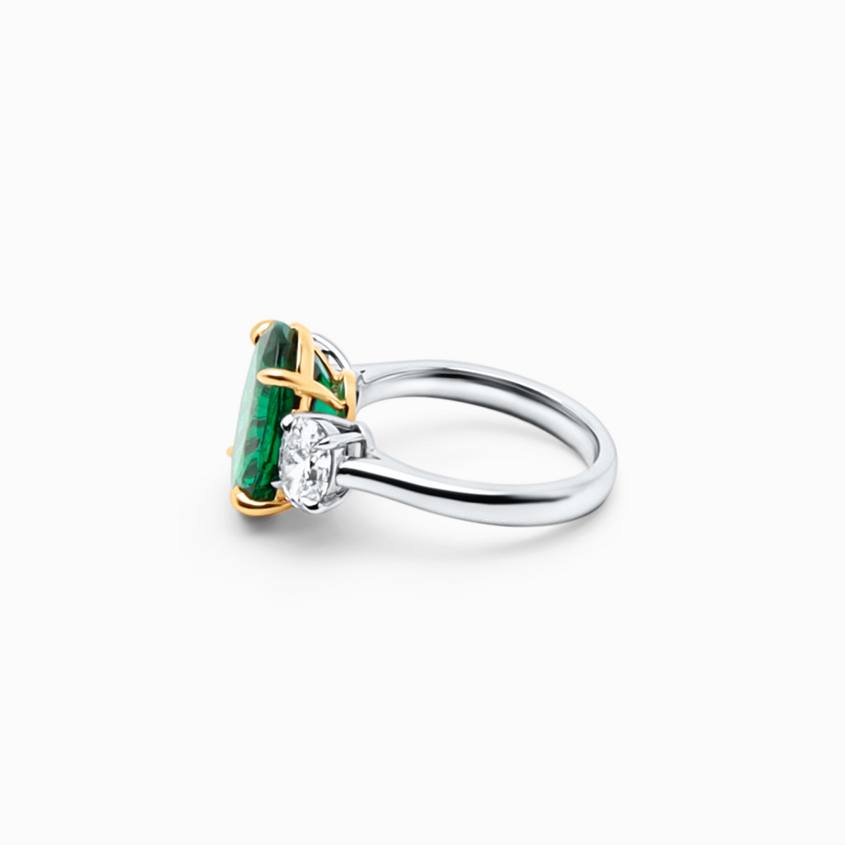 Elegant oval emerald and diamond ring featuring a 4.44 carat emerald center and sparkling oval diamond.