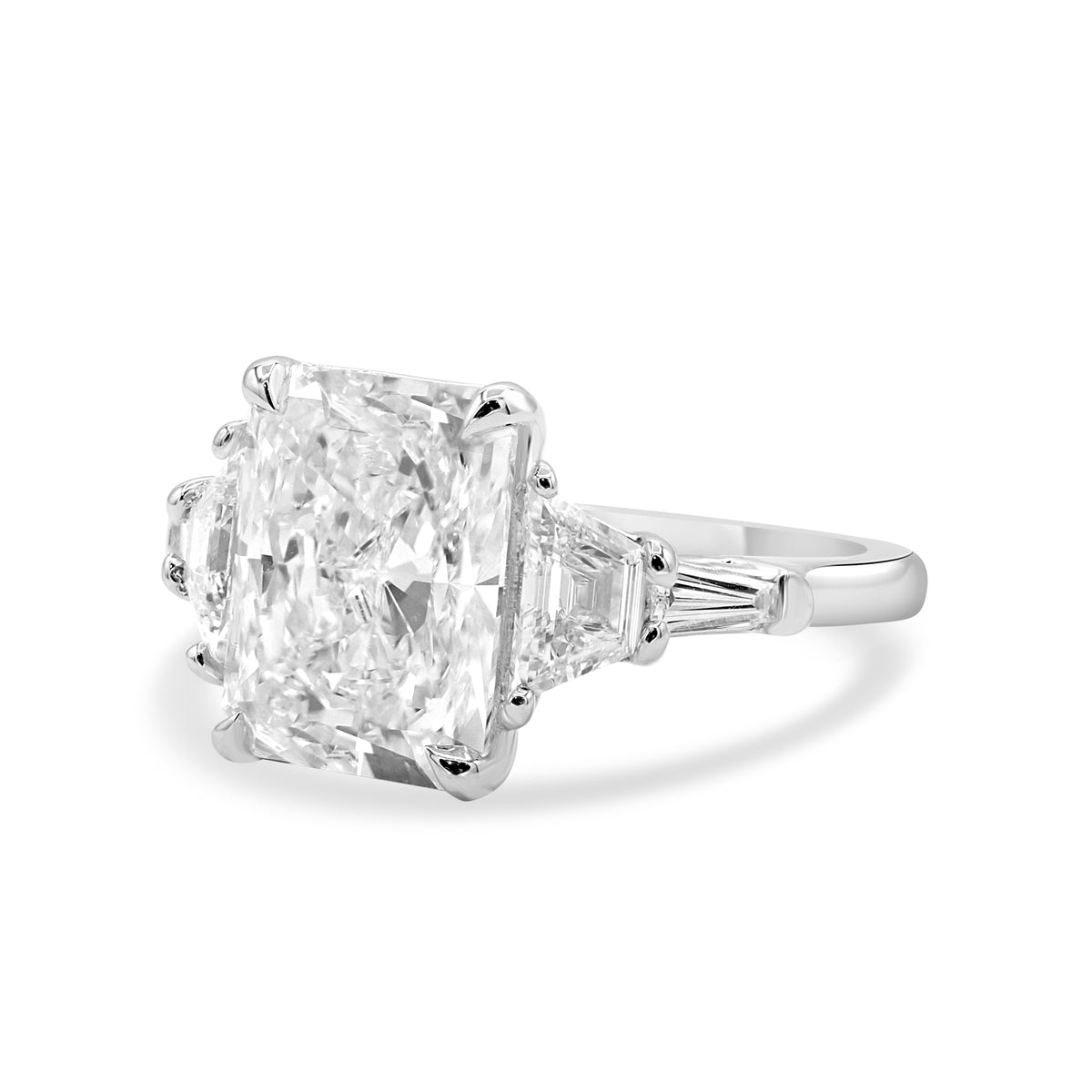 Platinum five-stone diamond ring with a 3.66 carat radiant cut center stone.