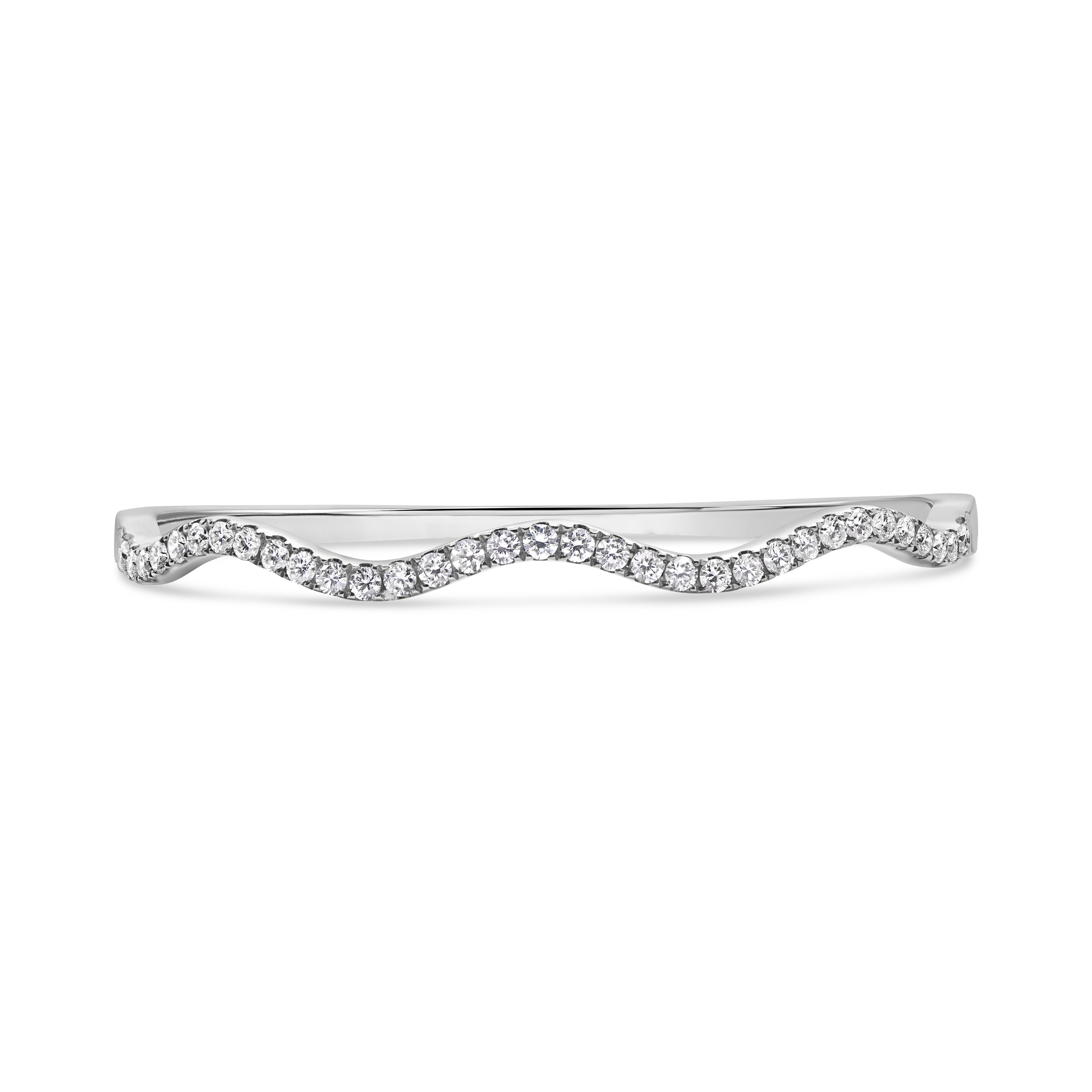 14K gold wave bangle featuring pavé-set round diamonds in a sleek curved silhouette.